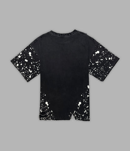 Black t-shirt with white splatter pattern on a gray background